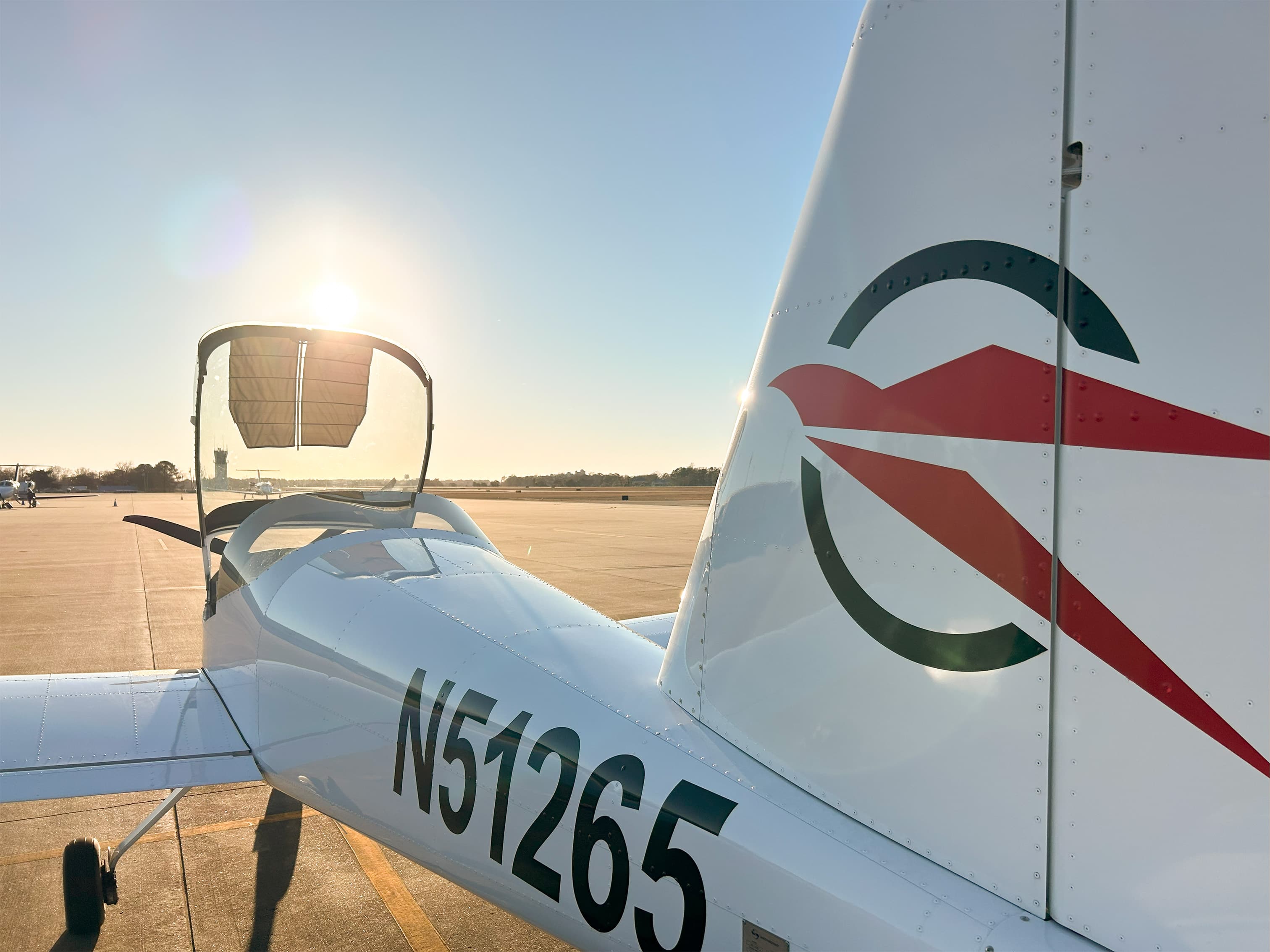 Falcon RV-12iS on the ramp with its canopy open and Falcon emblem on the tail